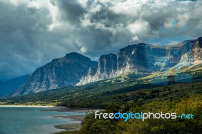 Storm Clouds Gathering Over Lake Sherburne Stock Photo