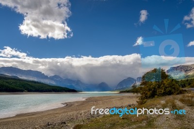 Storm Clouds Gathering Over Lake Sherburne Stock Photo