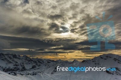 Stormy Clouds Over A Snowcaped Mountain Range Stock Photo