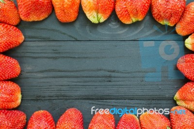 Strawberries Frame On Black Wooden Stock Photo