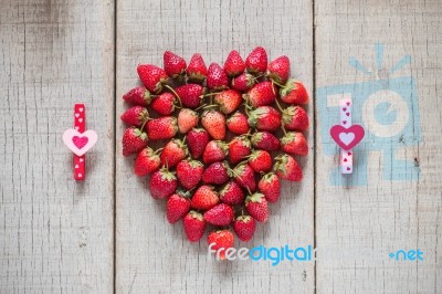 Strawberry And Heart On Wooden Stock Photo