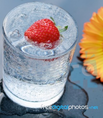 Strawberry On Sparkling Water Stock Photo