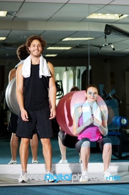 Strong Fit Man And Woman Posing Casually Stock Photo