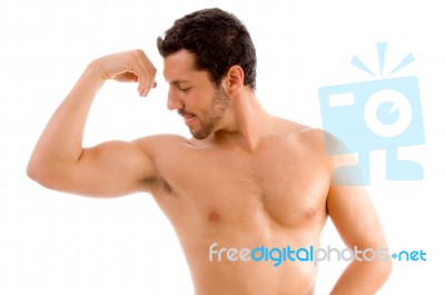 Strong Man Looking His Muscles Stock Photo