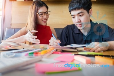 Student Couple Doing Homework With Laptop At Home Stock Photo