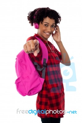 Student With Headphones On Indicating Towards You Stock Photo