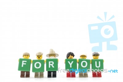 Studio Shot Of Lego Minifigure Holding Word For You On White Background Stock Photo