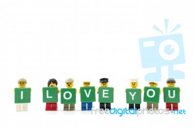 Studio Shot Of Lego Minifigure Holding Word I Love You On White Background Stock Photo