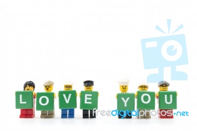 Studio Shot Of Lego Minifigure Holding Word Love You On White Background Stock Photo