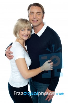 Stylish Man In Pullover Embracing His Blonde Wife Stock Photo