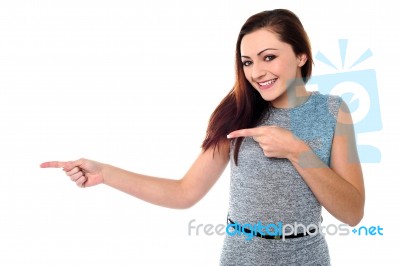 Stylish Teen Girl Pointing Away Stock Photo