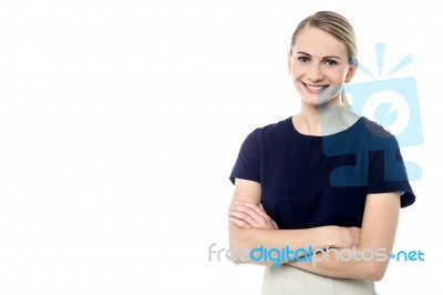 Stylish Woman Posing With Folded Arms Stock Photo