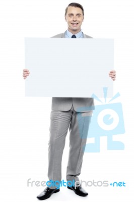 Successful Business Executive Holding Blank Ad Board Stock Photo