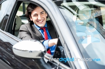 Successful Businessman Driving A Luxurious Car Stock Photo