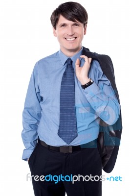 Successful Man Holding His Coat Over Shoulder Stock Photo