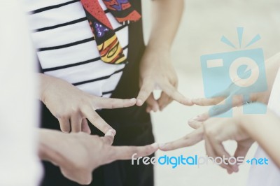 Successful Team Of Children Forming A Star With Their Fingers Touching To The Form The Points Stock Photo