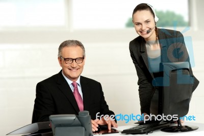 Successful Team Of Senior Man And Young Woman Stock Photo