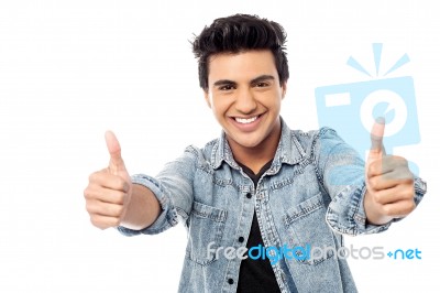 Successful Young Man Giving Thumbs Up Stock Photo