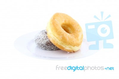 Sugar And Chocolate Donut Side View On Dish On White Background Stock Photo