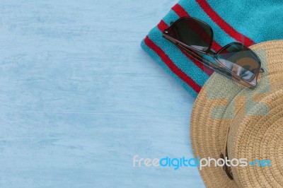 Summer Hat On Towel With Sunglasses Stock Photo