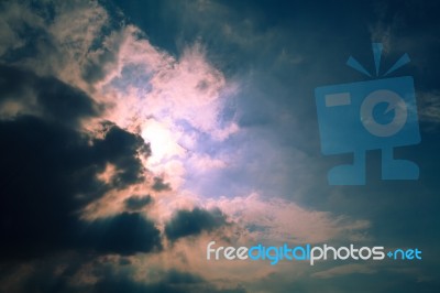 Sun Behind Clouds Background Stock Photo