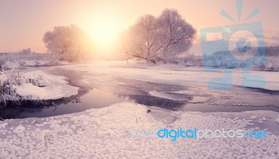 Sun Rising Above Icy Lake. Ice Pattern On Lake Stock Photo