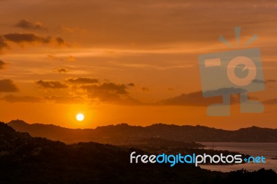 Sun Setting Beyond Palau In Sardinia Stock Photo