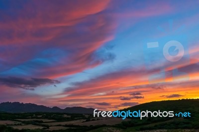 Sun Setting Beyond Palau In Sardinia Stock Photo