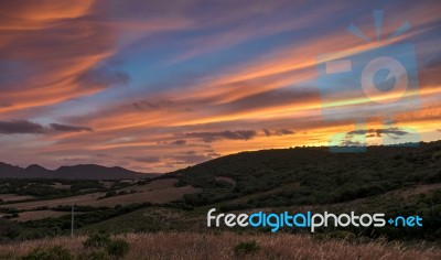 Sun Setting Beyond Palau In Sardinia Stock Photo