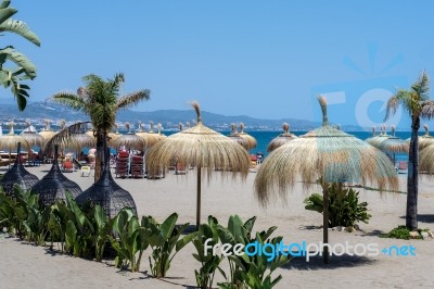 Sun Umbrellas On The Beach At Puerto Banus Stock Photo