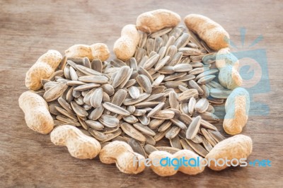 Sunflower And Peanut Seeds On Weathered Wood Stock Photo