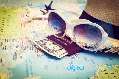 Sunglasses, Passport, Money, Hat And Aircraft On The World Map Stock Photo