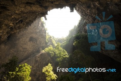 Sunlight Through A Cave Hole In Thailand Stock Photo