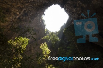 Sunlight Through A Cave Hole In Thailand Stock Photo