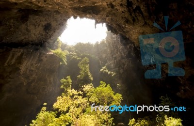 Sunlight Through A Cave Hole In Thailand Stock Photo