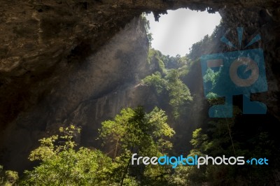 Sunlight Through A Cave Hole In Thailand Stock Photo