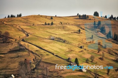 Sunny Spring Evening In Mountain Village. Fields And Hills Stock Photo