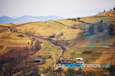 Sunny Spring In Mountain Village. Fields And Hills Stock Photo