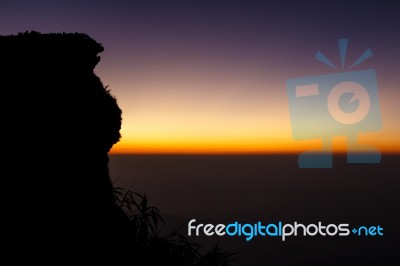 Sunrise And Sea Of Fog At Phu Chi Fa In Early Morning (silhouette) And Tourists At Tip Of Hill. Thailand Stock Photo