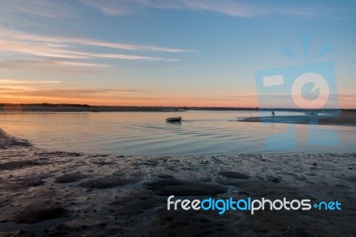 Sunrise Horizon Line On A Deserted Beach Stock Photo