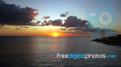 Sunrise In A Mediterranean Island Malta With A Cloudy Sky In Summer Stock Photo