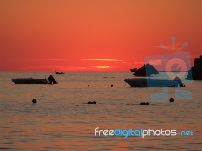 Sunrise In Mediterranean Island Malta, Orange Sky With Boats On A Horizon Stock Photo