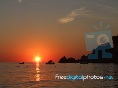 Sunrise In Mediterranean Island Malta, Orange Sky With Boats On A Horizon Stock Photo