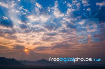 Sunrise Rays On Morning Blue Orange Sky Cloud With Mountain Stock Photo