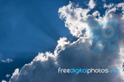 Sun's Rays Behind The Cloud Stock Photo