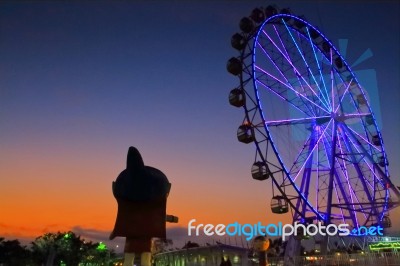 Sunset And Giant Wheel Stock Photo