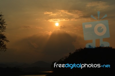 Sunset And Silhouette Mountain Stock Photo