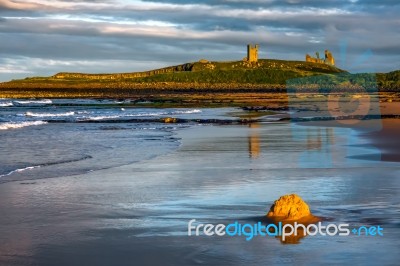 Sunset At Dunstanburgh Castle Stock Photo