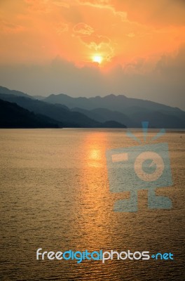 Sunset Over A Mountain At Lake Stock Photo