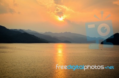 Sunset Over A Mountain At Lake Stock Photo